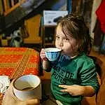 Photograph, Drinkware, Tableware, Cup, Table, Coffee Cup, Dishware, Serveware, Chair, Happy, Tea, Drink, Bois, Leisure, Bambin, Plate, Mug, Teacup, Porcelain, Personne